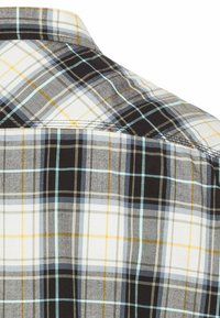 Schwarz-weiße Karierte Bluse mit grauen, blauen und gelben Akzenten. Sie hat einen spitzen Kragen und kurze Ärmel. Glattes Baumwollmaterial.