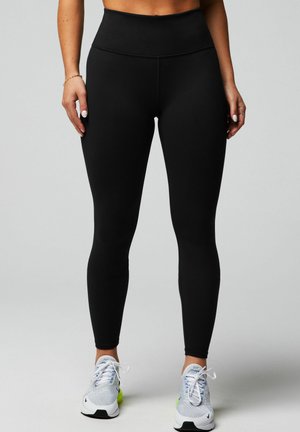 Black high-waisted leggings made from stretchy material, featuring a smooth texture, form-fitting shape, and no visible patterns or hardware.