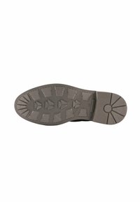 Suola di stivaletti neri in gomma con motivi di grip texture, caratterizzata da tasselli tridimensionali triangolari e rettangolari per maggiore aderenza e durata.
