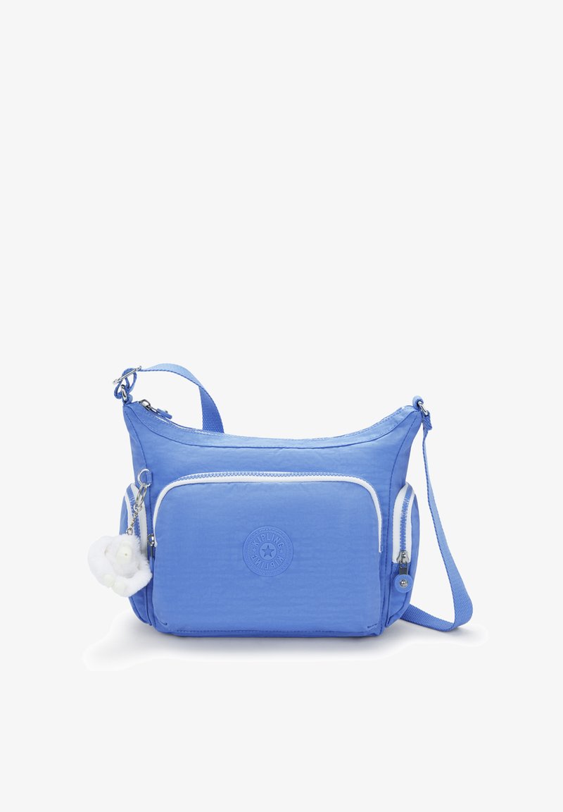 Blue nylon messenger bag with white zippers and logo. Features adjustable strap and front pocket with a fluffy charm accessory.
