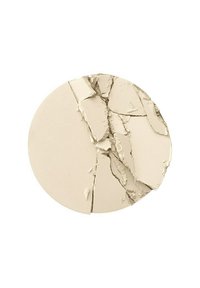 Cracked beige powder in a round compact, featuring a smooth texture, fine particles, and irregular breaks across the surface.