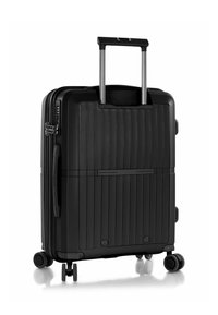 Valigia rigida nera con finitura testurizzata, strisce verticali, manico estraibile e quattro ruote piroettanti per una facile mobilità.
