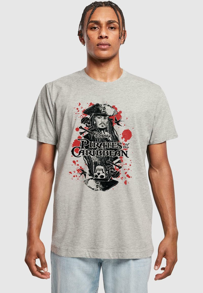 Gray cotton t-shirt featuring a black and red graphic print of a pirate, with splashes of red and "Pirates of the Caribbean" text.