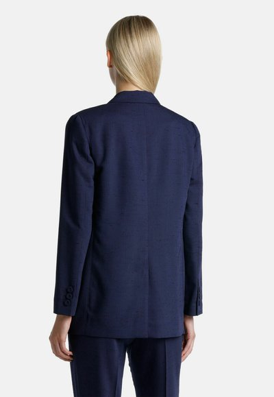 Navy blue tailored blazer with a smooth texture, single back vent, and three-button cuffs. Features a classic lapel design.