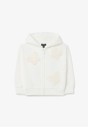 Haut à capuche zippé blanc avec une texture douce et moelleuse, orné de trois appliqués en forme de nu texturés à l'avant. Comprend une capuche et des poignets côtelés.