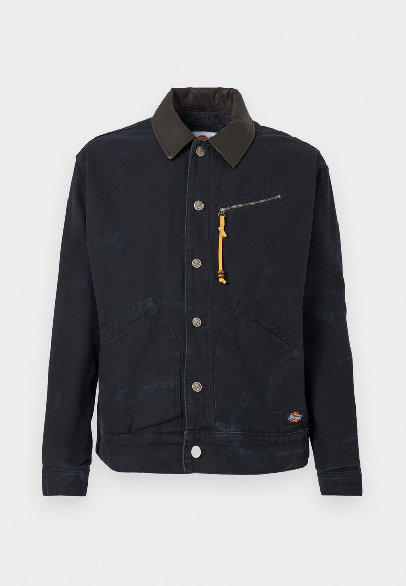 Black button-up jacket with dark contrast collar, two front pockets, a zippered chest pocket with yellow pull tab, and a small logo patch.