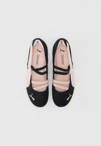 Black and pink ballet flats made of soft suede, featuring crisscross elastic straps and a cushioned Ortholite insole. Puma logo on side.