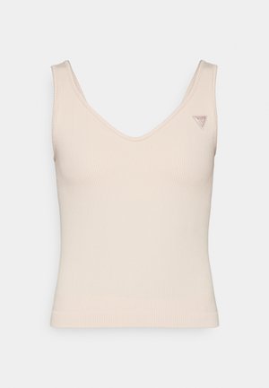 Ribbet, ærmeløs beige top med V-hals design. Har et lille logo på venstre skulder. Blød tekstur med en tætsiddende silhuet.