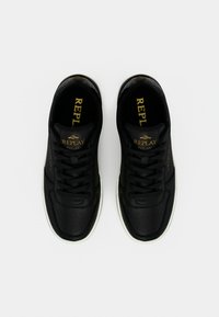 Μαύρα δερμάτινα αθλητικά παπούτσια με διάτρητο σχέδιο, λευκή σόλα και χρυσό λογότυπο "REPLAY" στη γλώσσα και στο πλάι. Απλή δέσιμη κορδόνια.