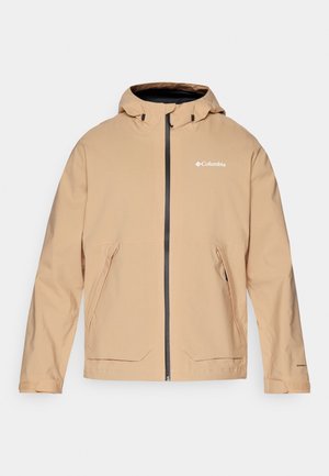 Beige vanntett jakke med hette, glidelås og to frontlommer. Har kontrasterende svarte glidelåser og logo detaljer. Glatt tekstur.