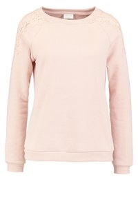 Felpa rosa chiaro dalla vestibilità comoda, con un dettaglio in pizzo sulle maniche raglan e polsini e orlo a coste. Materiale morbido e strutturato.