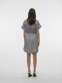 Robe courte rayée en tissu doux avec une taille ceinturée, des manches larges et une forme fluide. Schéma de couleurs : bleu marine et blanc.