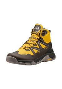 Botte de randonnée jaune et marron en mesh et caoutchouc, avec une conception montante, des accents texturés et des lacets noirs contrastants.