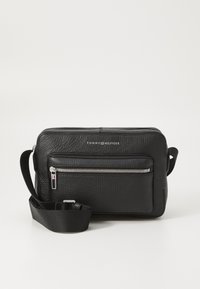 Schwarze Leder-Umhängetasche mit strukturiertem Außenmaterial, silbernen Reißverschlussakzenten, markiertem Logo auf der Vorderseite und verstellbarem Tragegurt.