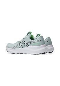 Ljusgröna löparskor med svarta detaljer, texturerad övre del, vadderad vit sula och gröna detaljer på tungan och hälen.