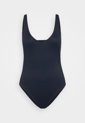 Maillot de bain une pièce côtelé bleu marine avec un décolleté en forme de scoop profond et des bretelles larges, présentant une ouverture de jambe haute et un tissu texturé.