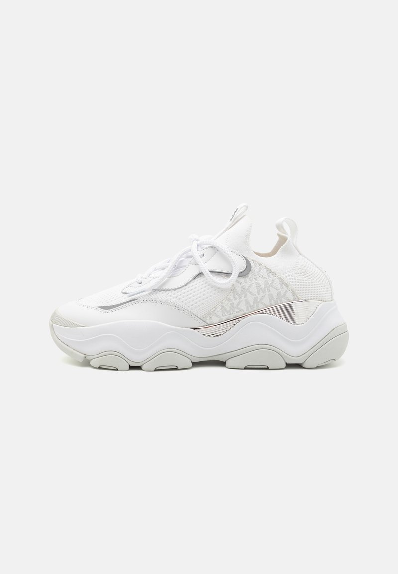 White athletic sneakers featuring a textured mesh upper, smooth white accents, rounded sole, and subtle logo detail on the side.