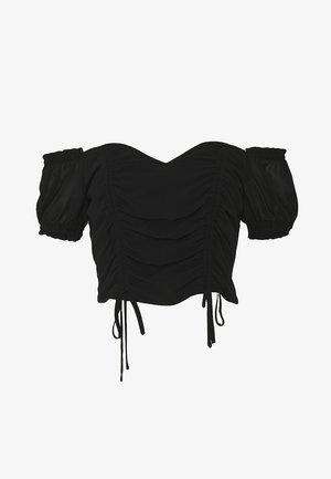 Blouse noire courte à manches bouffantes, dotée de fronces et de liens réglables à l'ourlet pour un ajustement près du corps. Texture lisse.