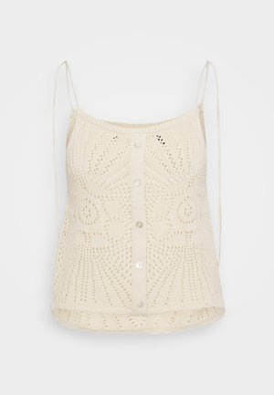 Top de punto color beige claro con escote redondeado, tirantes delgados ajustables y cierre de botones en la parte delantera. Presenta patrones de encaje intrincados.