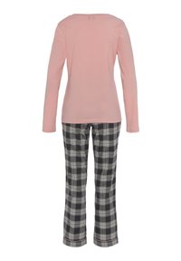 Long-sleeve pink top paired with black plaid pants featuring white and gray lines, detailed with a red accent at the hem.