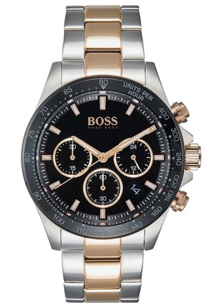 Men's wristwatch with black dial, gold and silver metal strap, three subdials, date window at 4 o'clock, and BOSS Hugo Boss branding.