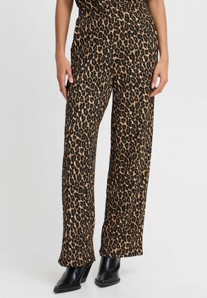 Leopard print wide-leg pants featuring a soft texture in shades of brown and black, paired with black heeled ankle boots.