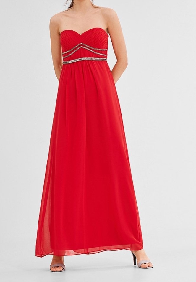 Robe longue rouge sans bretelles en tissu léger, avec un corsage froncé orné d'accents argentés brillants et une jupe fluide.