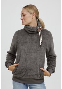 Grå fleecetröja med krage, framfickor och snoddar med trädetaljer. Texturerat tyg, långa ärmar, ribbad nederkant.