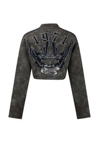 Cropped, black faux leather jacket with long sleeves. Features eagle graphics, the year "1971," and text banner on the back.