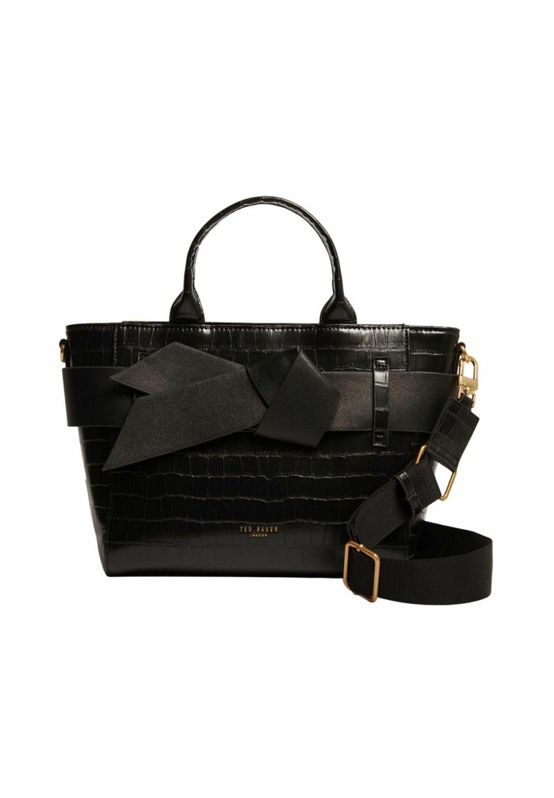 Sac en cuir noir embossé crocodile avec double anses, un grand accent en forme de nœud, une bandoulière réglable et des détails en métal doré.