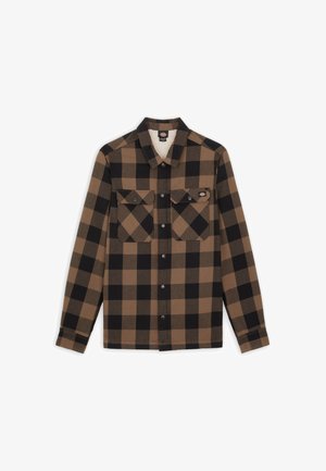 Camicia a quadri marrone e nera con maniche lunghe, apertura con bottoni, due tasche sul petto e una morbida fodera bianca. Realizzata in un tessuto testurizzato.