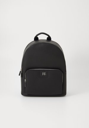 Black backpack with a rounded top, made of textured material, featuring a front zip pocket and a handle on top. Silver hardware accents.