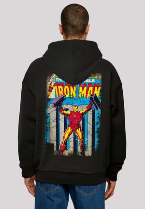 Black hoodie featuring an Iron Man graphic in vibrant red and yellow, with a textured comic book-style background and blue accents.