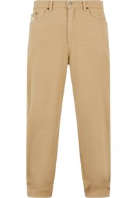 Beige puuvillapantsit suoran leikkauksen omaavina, joissa on vetoketjukiinnitys, viisi taskua ja hienovaraiset ompeluyksityiskohdat. Sujuva pinta ja klassinen muotoilu.