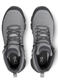 Gray hiking boots made of mesh and rubber, featuring a high-top design, laces, and waterproof details. Logo and size label visible inside.