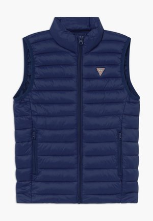 Chaleco acolchado sin mangas azul marino con cremallera frontal, cuello alto, dos bolsillos con cremallera y un pequeño logo triangular de Guess en el pecho.