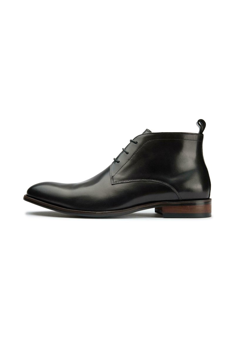 Black leather ankle boots with a sleek, pointed toe, featuring three eyelets for laces and a wooden heel accent.