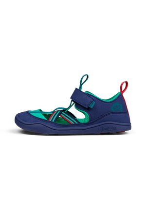 Navy blue children's sandal with green accents, strap closure, open heel design, textured sole, and striped elastic detailing.