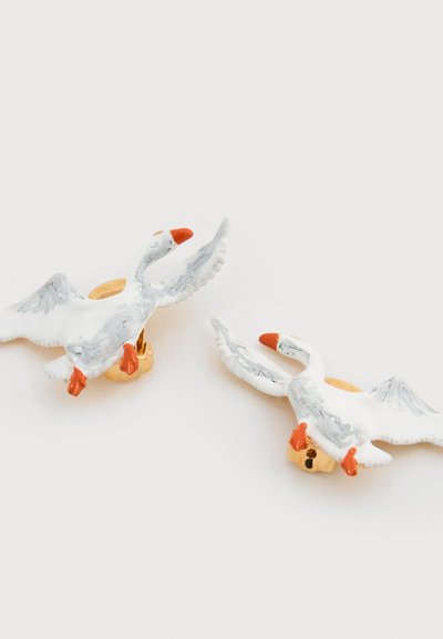 Keramiske svaneøredobber i hvitt med grå marmorering, med oransje nebb og føtter. Gullfarget maskinvare for sikker feste.