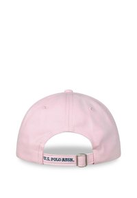 Pink cotton baseball cap with an adjustable strap. Features "U.S. POLO ASSN." embroidered in blue on the rear. Smooth texture, rounded shape.