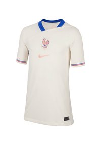Crèmekleurig voetbalshirt met korte mouwen en blauwe kraag, met rode en blauwe strepen op de mouwen, en een hanenembleem en Nike-logo in het roze.