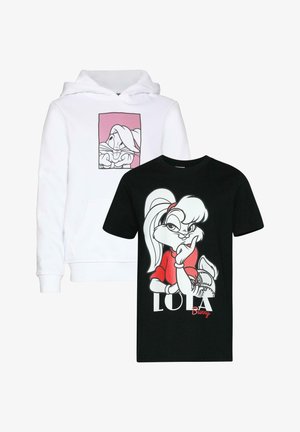 Czarna bawełniana koszulka z nadrukiem postaci z kreskówki w białym i czerwonym kolorze oraz napisem "LOLA Bunny". Połączona z jasnoniebieskimi dżinsami o szerokich nogawkach i jasnobeżowymi butami.