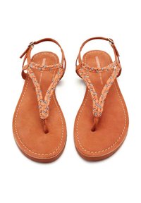 Chanclas de cuero marrón con tiras trenzadas naranjas y acentos decorativos de plata; diseño de punta abierta con suela plana que presenta bordes cosidos.