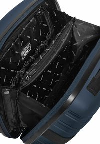 Blauwe rugzak met een gestructureerde buitenkant. Binnenin heeft hij een zwarte voering met een patroon van kleine witte sterren en een logo. Meerdere vakken en ritsen.