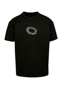 Sort t-shirt lavet af bomuld med et cirkulært design af sølvspidser på fronten, hvilket skaber et textured, grafisk udseende.