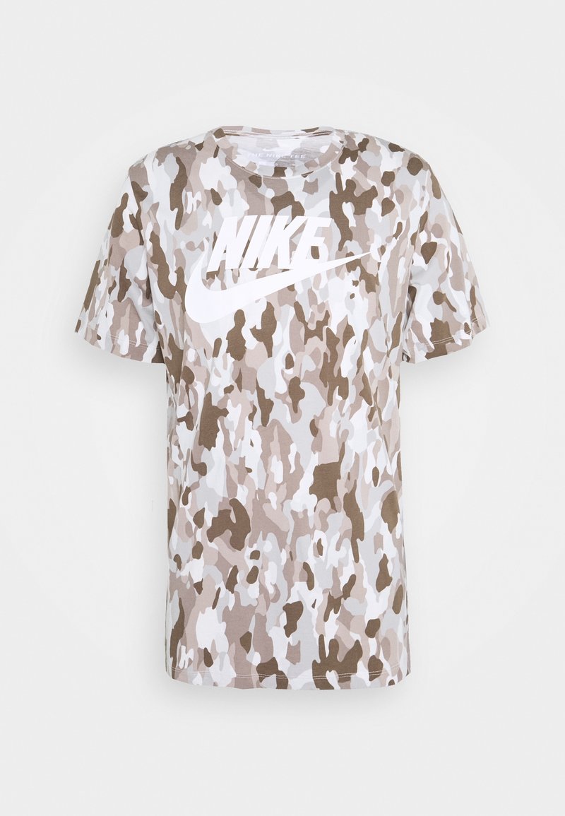 Short-sleeved T-shirt featuring a beige and white camouflage pattern, with a large white Nike logo across the chest. Made of soft fabric.