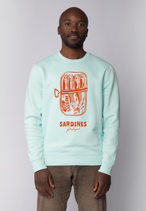 Mintgrüner Kapuzenpullover mit einer grafischen Illustration einer Sardinenbüchse in Orange, darunter der Text "SARDINES Portugal".