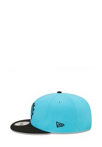 Light blue cap with a black visor; features an embroidered design on the front, and a logo on the side. Made from fabric with a smooth texture.