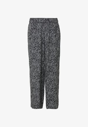 Schwarz-weiße gemusterte Hose mit elastischem Bund, lockerer Passform und geometrischen Diamantmustern auf dem Stoff.