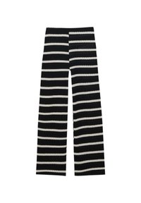 Pantalons larges à rayures noires et blanches avec une texture côtelée, mettant en avant des rayures audacieuses alternées et un ajustement décontracté.